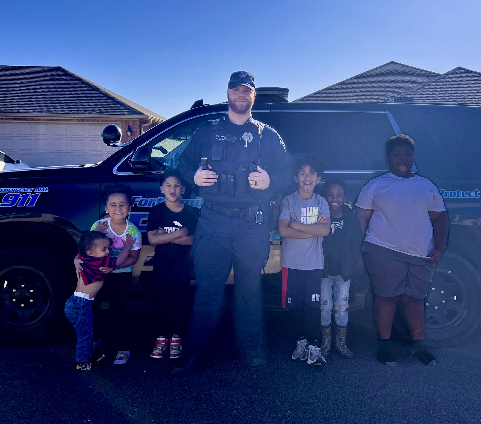 officer posing with children