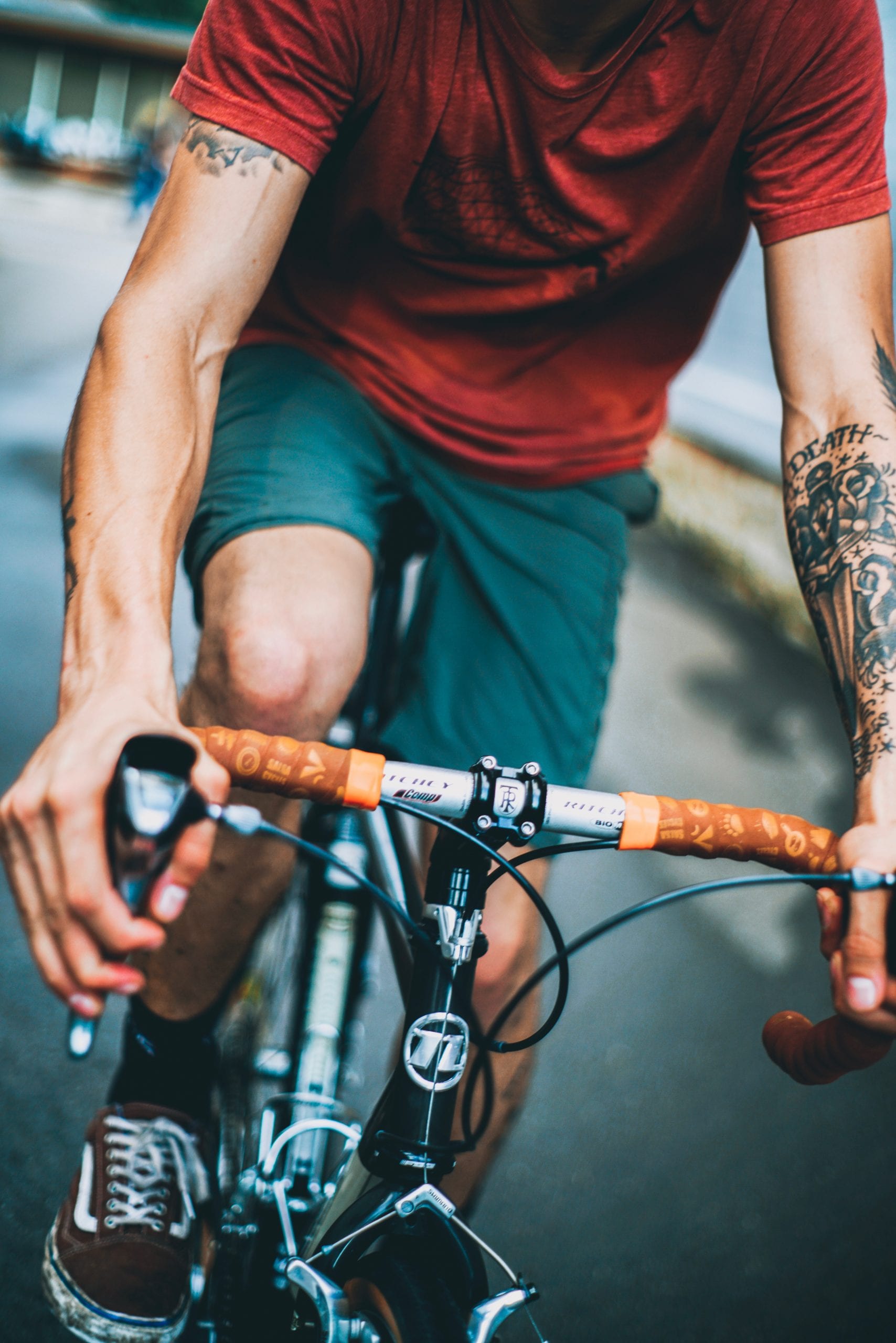 Cyclist with tattooed arms