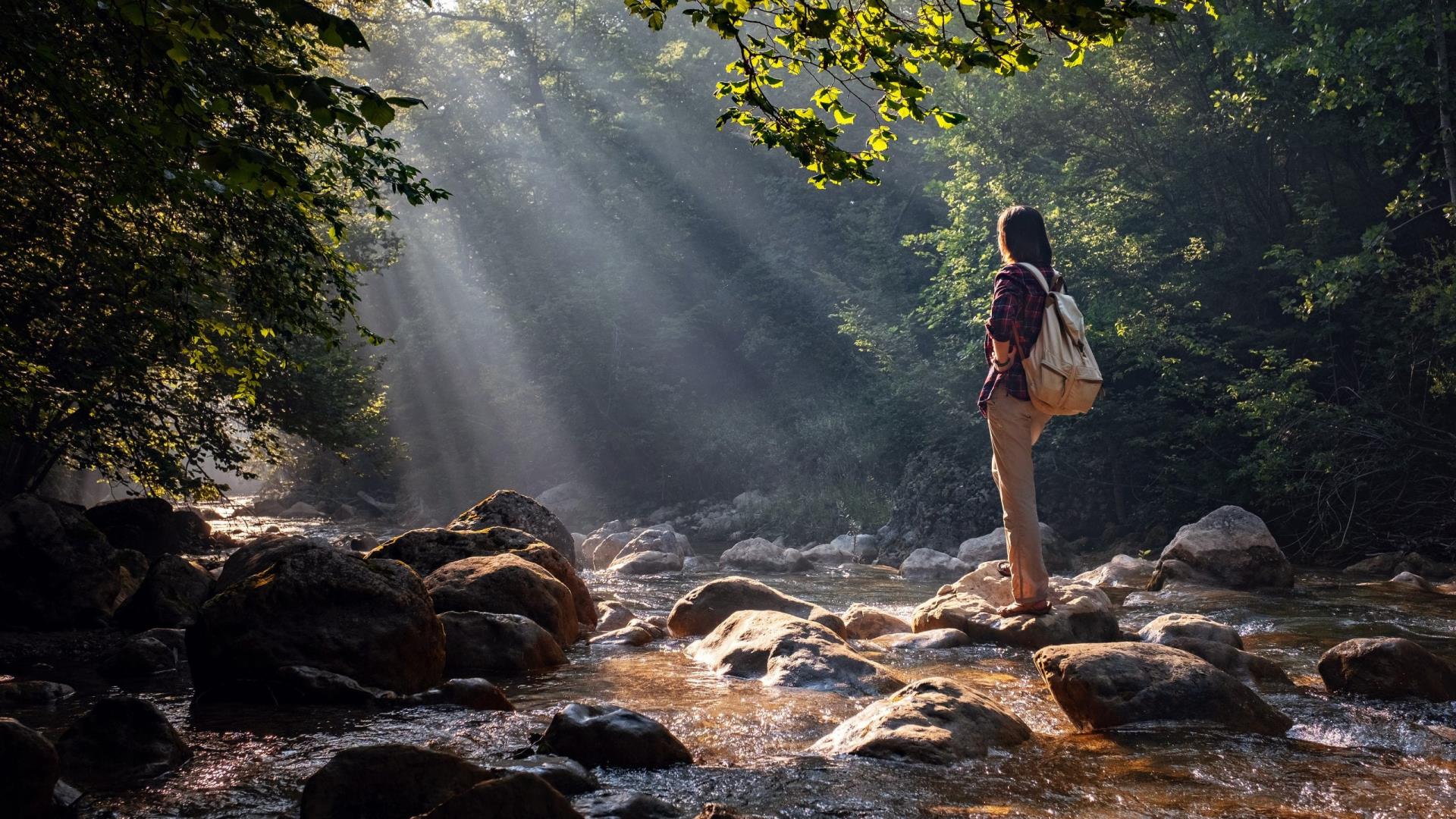 Hiker standing on rocks in a river